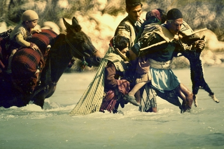 A group of Bakhtiari people crossing a river